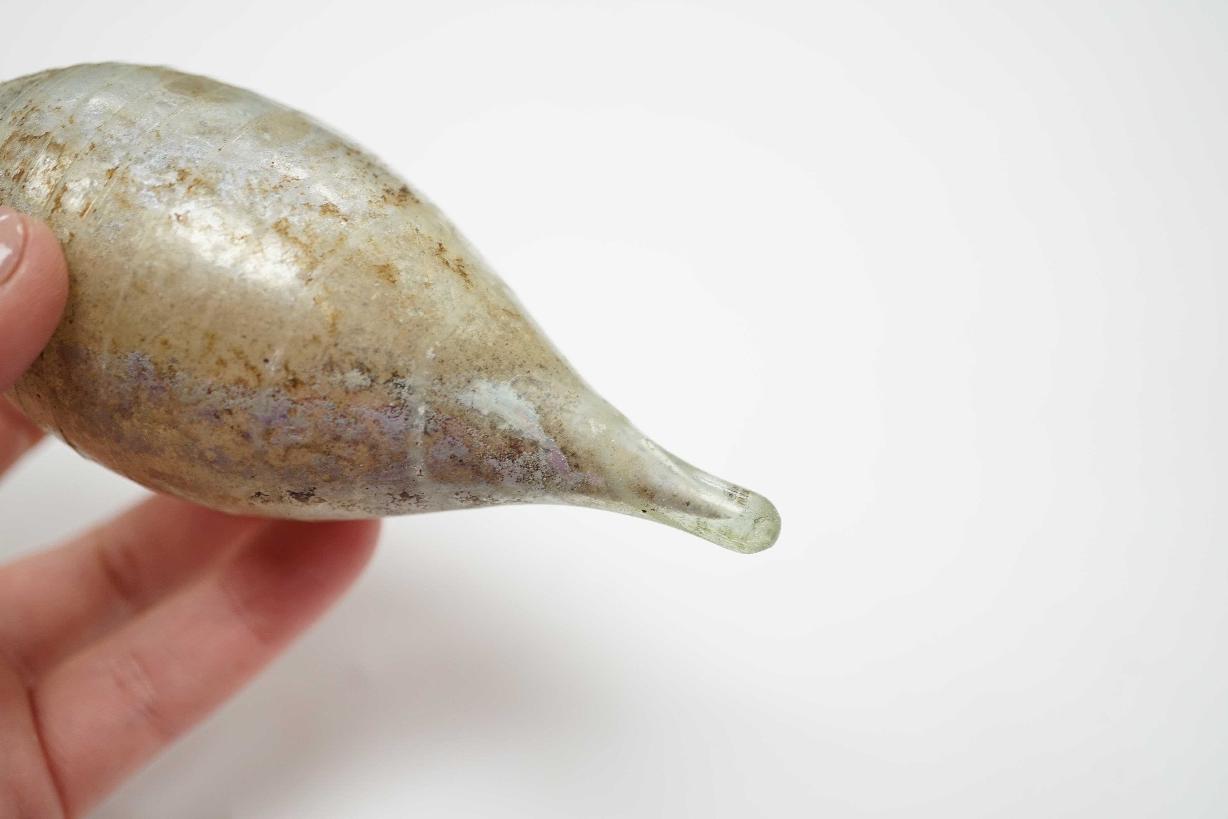 A Roman glass unguentarium, with trailed decoration, 14cm